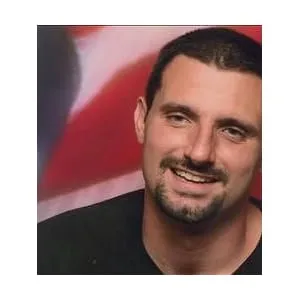 Daniel Martin Molliver, author of 'Making Your Own Trail,' smiling in front of an American flag background. Biography section describing his journey and struggles leading to personal empowerment